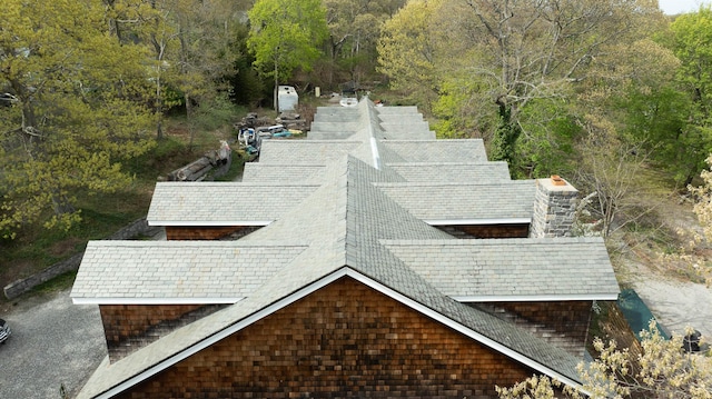 drone / aerial view featuring a wooded view