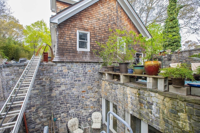 view of property exterior with stone siding