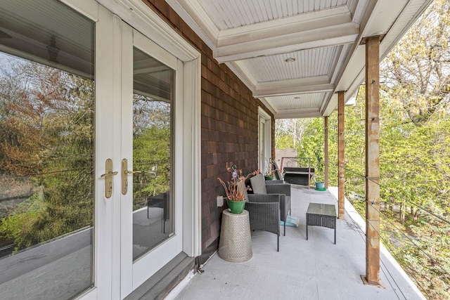 view of patio / terrace featuring a porch and french doors