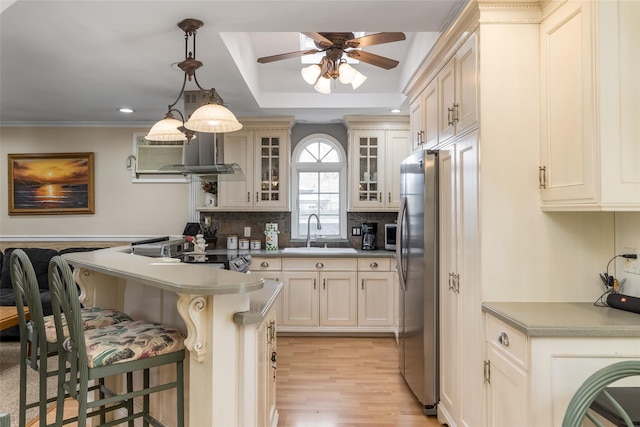431 Grand Blvd, Brentwood, NY 11717 - kitchen with a sink, freestanding refrigerator, backsplash, ceiling fan, and a breakfast bar