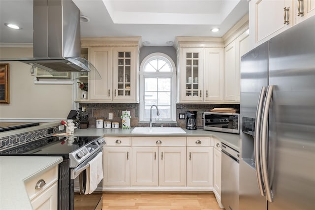 431 Grand Blvd, Brentwood, NY 11717 - kitchen featuring tasteful backsplash, a sink, island exhaust hood, light countertops, and appliances with stainless steel finishes