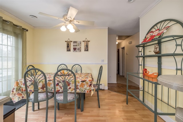 431 Grand Blvd, Brentwood, NY 11717 - dining space with a ceiling fan, baseboards, crown molding, and wood finished floors