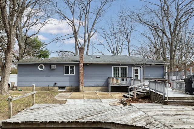 431 Grand Blvd, Brentwood, NY 11717 - back of property with a wooden deck, a shingled roof, and an attached garage