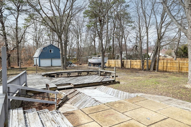 431 Grand Blvd, Brentwood, NY 11717 - wooden terrace featuring fence, an outbuilding, and a detached garage