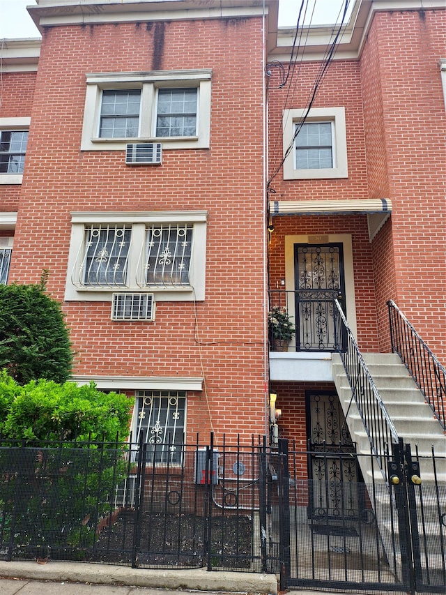 view of property with brick siding and a fenced front yard