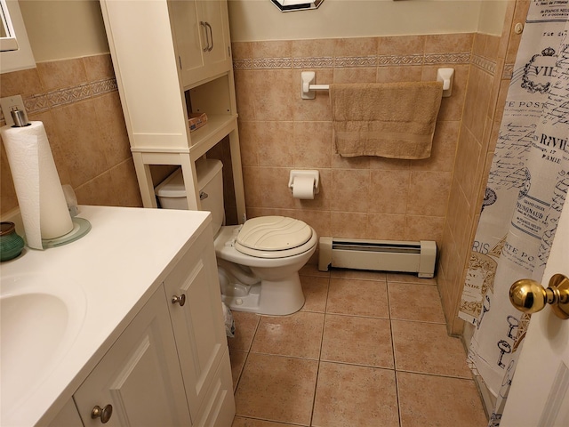 bathroom featuring vanity, baseboard heating, tile patterned flooring, toilet, and tile walls