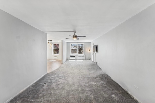 hall featuring radiator heating unit and carpet flooring
