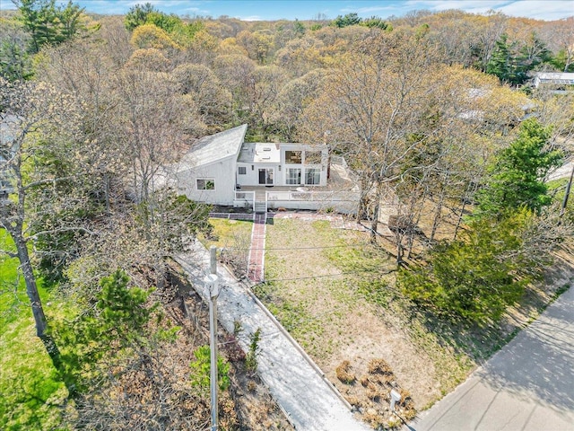 birds eye view of property with a wooded view