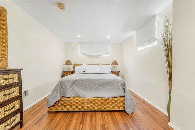 bedroom featuring recessed lighting, baseboards, visible vents, and wood finished floors