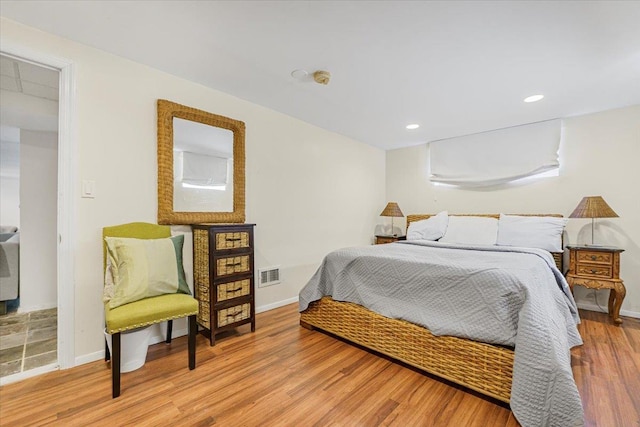 bedroom with visible vents, recessed lighting, light wood finished floors, and baseboards