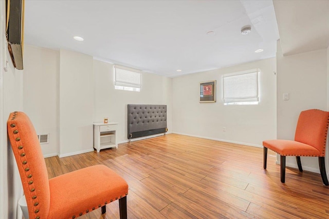 sitting room featuring baseboards, recessed lighting, and wood finished floors