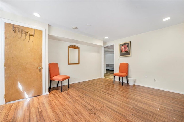 unfurnished room with light wood-style floors, baseboards, and recessed lighting