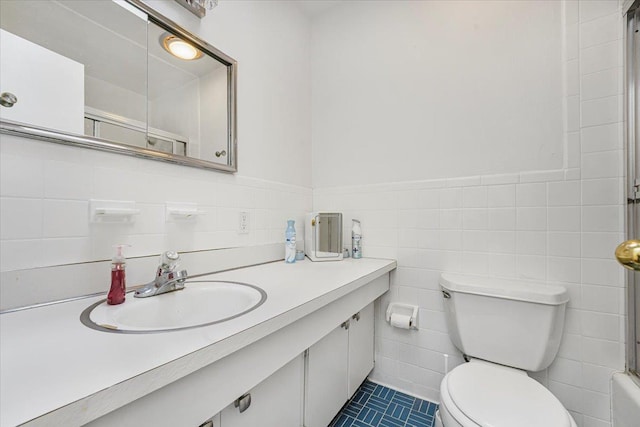 full bath with tile walls, tile patterned flooring, walk in shower, vanity, and toilet