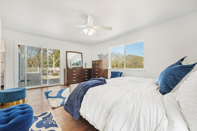 bedroom with access to outside, ceiling fan, and wood finished floors