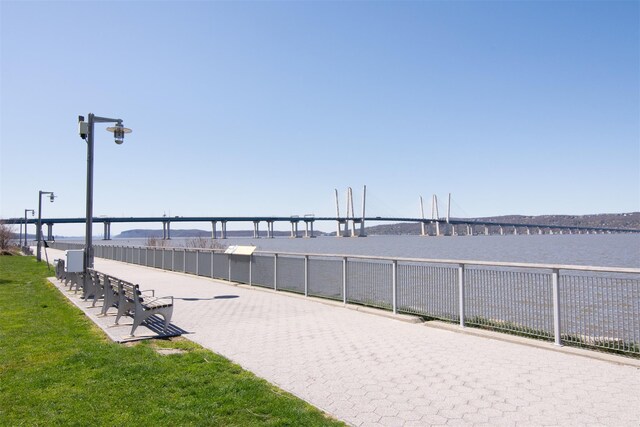 18 Rivers Edge Dr Unit 506, Tarrytown, NY 10591 - surrounding community with a water view and a lawn