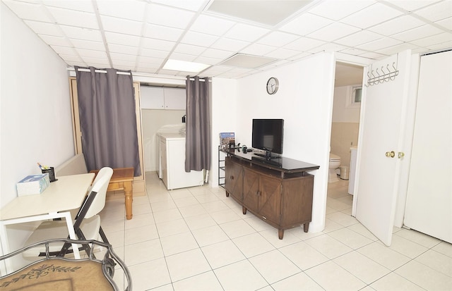 office featuring light tile patterned floors and independent washer and dryer