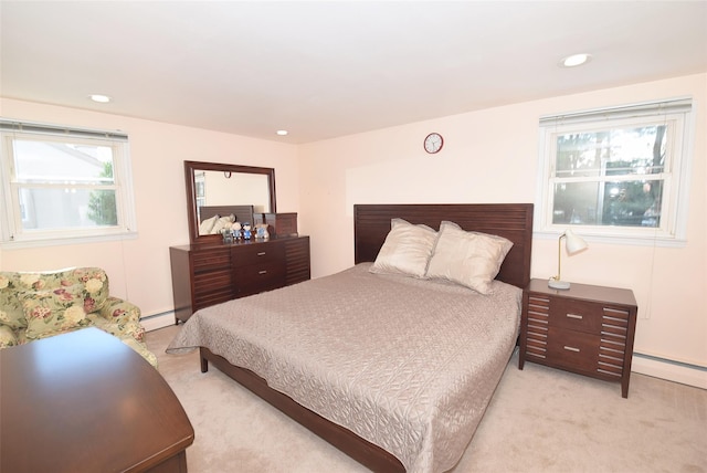 bedroom with a baseboard radiator, light carpet, and recessed lighting