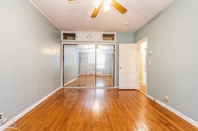 unfurnished bedroom with a closet, light wood-type flooring, baseboards, and ceiling fan