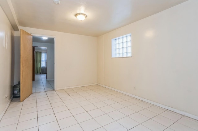 spare room featuring light tile patterned flooring