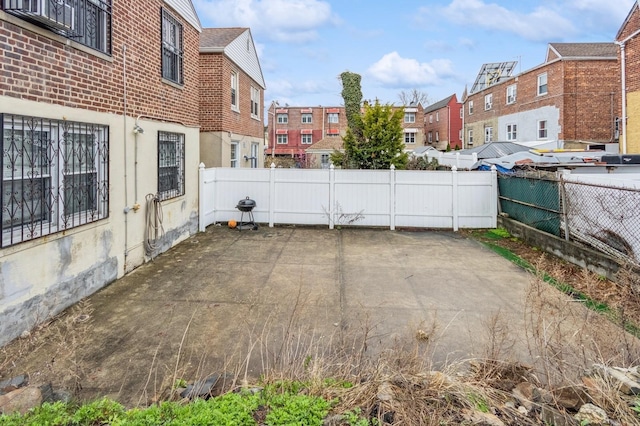 view of patio with a residential view and fence
