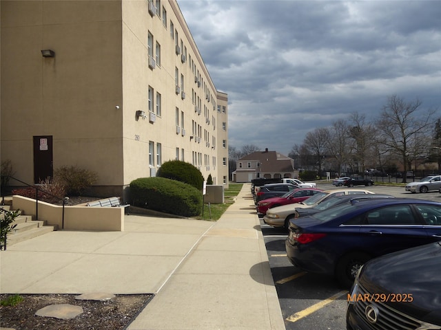 view of building exterior featuring uncovered parking