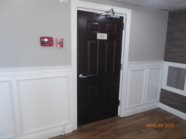 interior space featuring wainscoting and dark wood finished floors