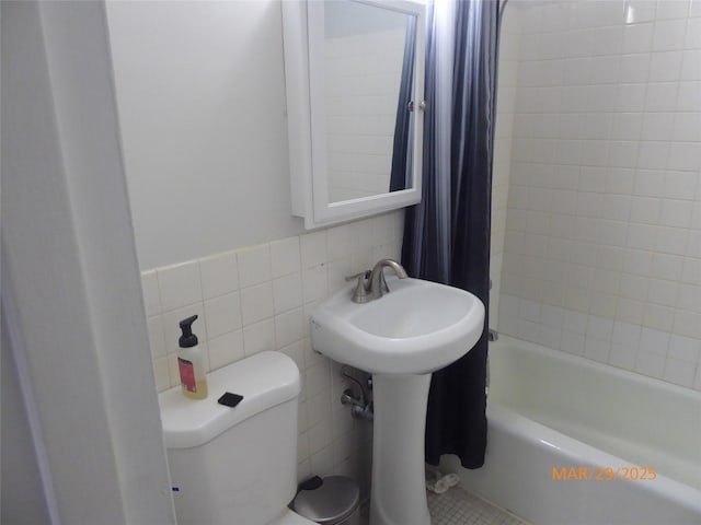 full bathroom with toilet, shower / bathtub combination with curtain, and tile walls