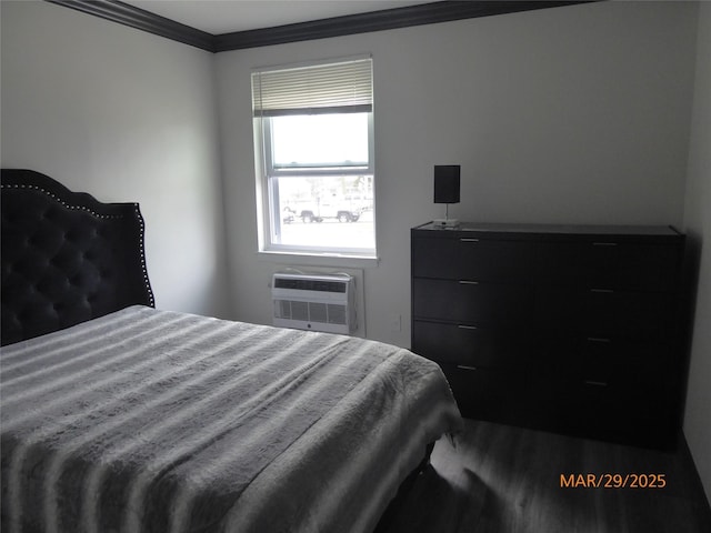 bedroom featuring a wall mounted air conditioner, ornamental molding, and wood finished floors