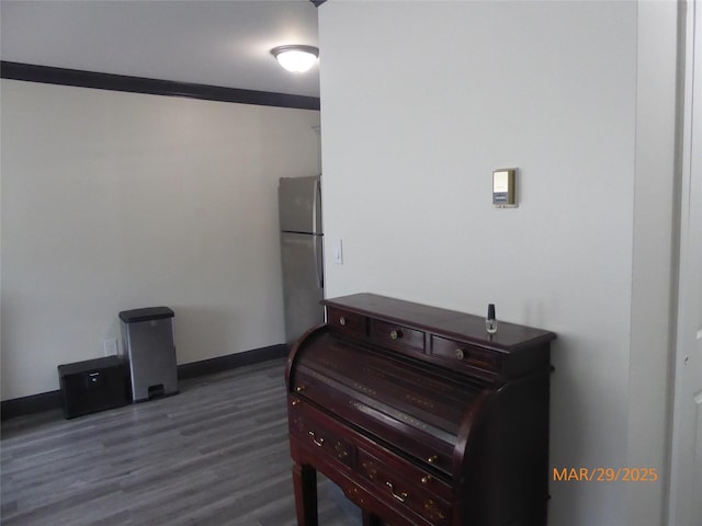interior space with baseboards and wood finished floors