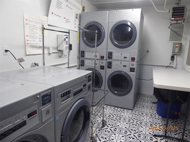 common laundry area with stacked washing maching and dryer, visible vents, independent washer and dryer, and tile patterned flooring