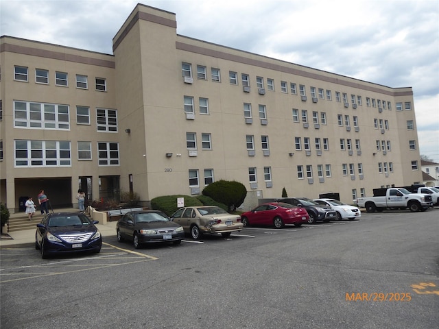view of building exterior featuring uncovered parking