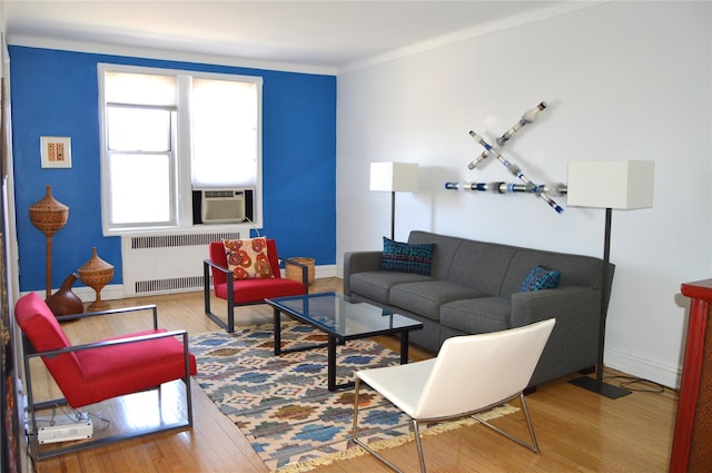 living room with cooling unit, baseboards, radiator heating unit, and hardwood / wood-style floors