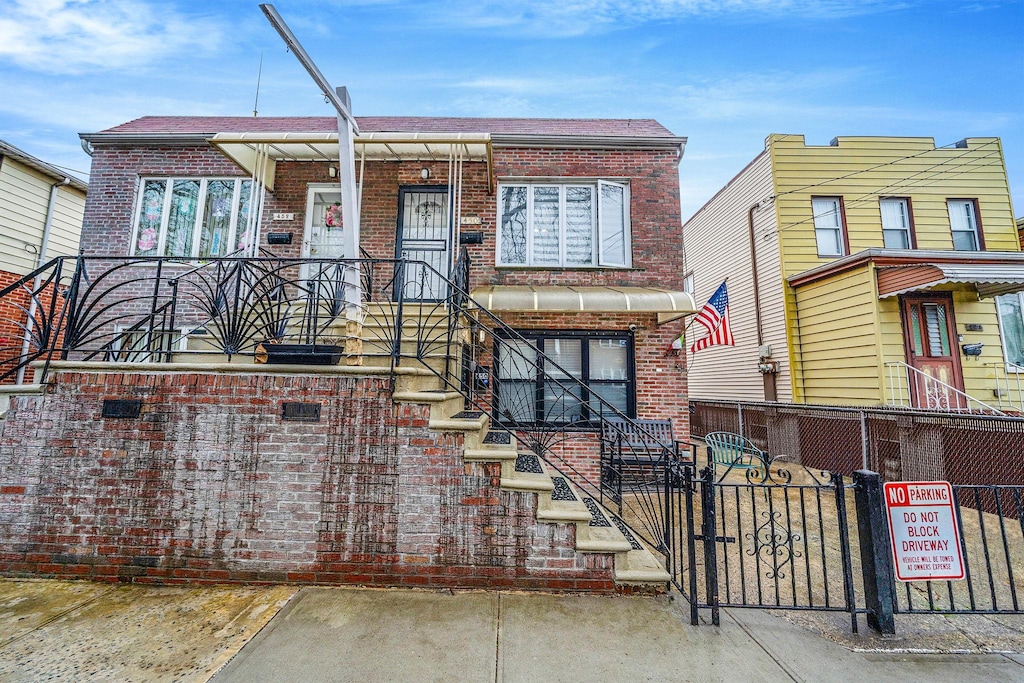 450 Lake St, Brooklyn, NY 11223 - view of front facade featuring brick siding, fence, and a gate