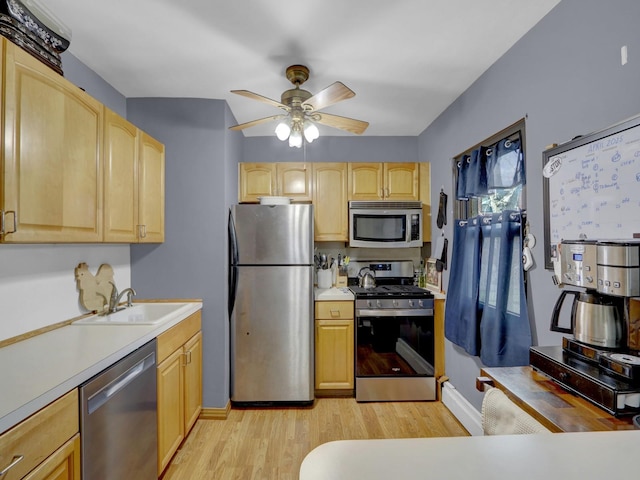 91 Tulip Ave Unit E1, Floral Park, NY 11001 - kitchen with stainless steel appliances, light brown cabinetry, light wood finished floors, and a sink