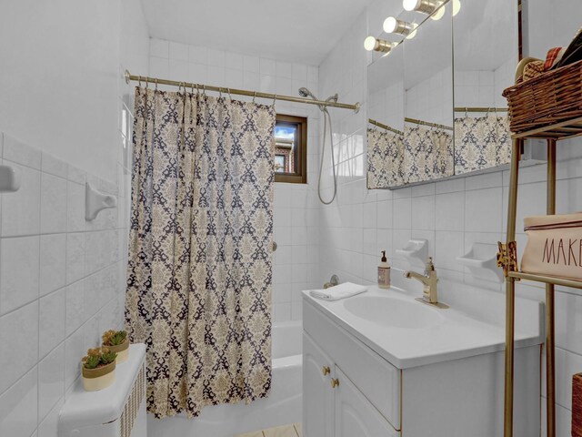 91 Tulip Ave Unit E1, Floral Park, NY 11001 - bathroom featuring tile walls, shower / bathtub combination with curtain, and vanity