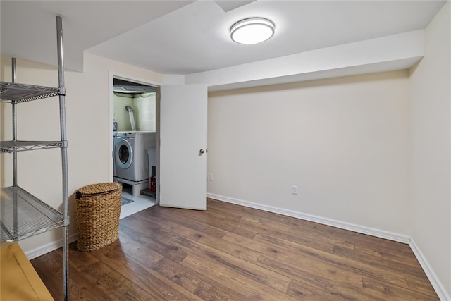 finished basement featuring washer / dryer, wood finished floors, and baseboards