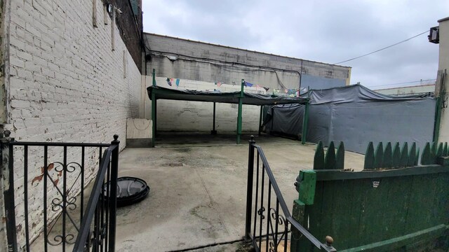 view of patio featuring a trampoline and fence