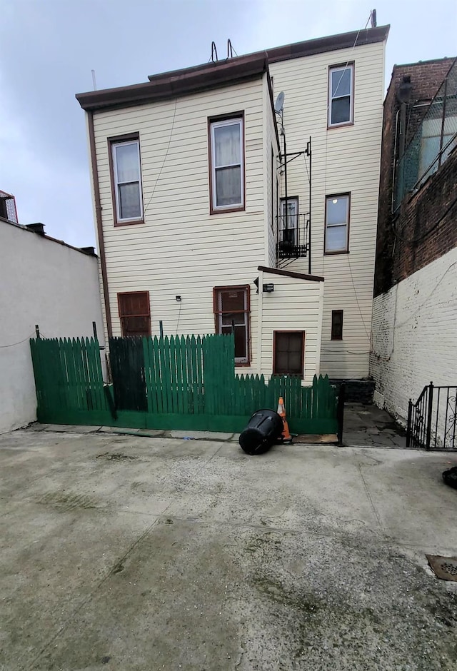 back of house featuring fence