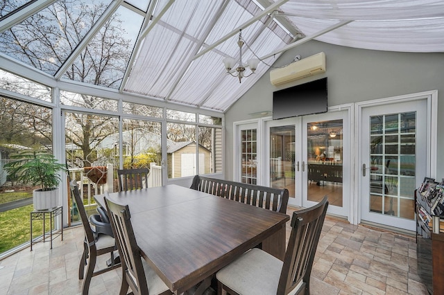 sunroom / solarium featuring a wall mounted AC, plenty of natural light, a notable chandelier, and french doors