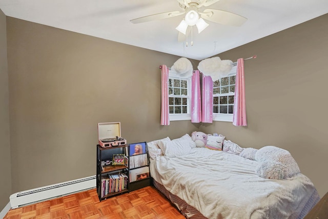 bedroom with baseboard heating and ceiling fan