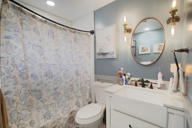 bathroom featuring toilet, recessed lighting, curtained shower, and vanity