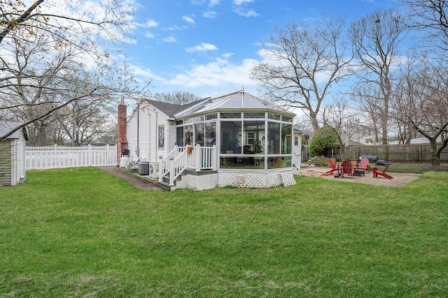 back of house with a patio area, a fenced backyard, central AC, and a sunroom