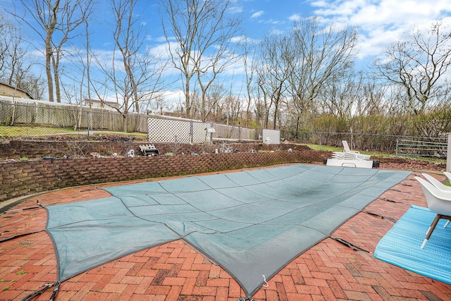 view of swimming pool featuring a patio area and a fenced backyard