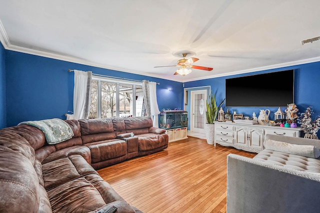 living room featuring hardwood / wood-style flooring, ornamental molding, and a ceiling fan