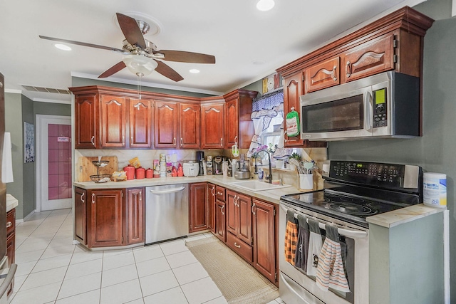 kitchen with stainless steel appliances, light countertops, a sink, and ceiling fan