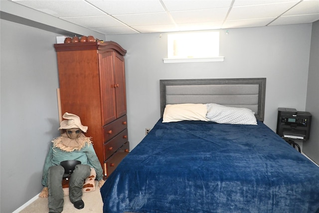 carpeted bedroom featuring a paneled ceiling