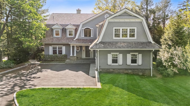 32 Pryer Ln, Larchmont, NY 10538 - view of front of house with a gambrel roof, a chimney, and a front lawn