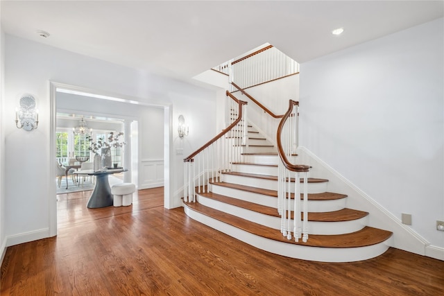 32 Pryer Ln, Larchmont, NY 10538 - stairway featuring an inviting chandelier, baseboards, and wood finished floors
