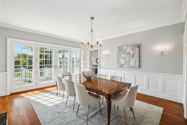 32 Pryer Ln, Larchmont, NY 10538 - dining area featuring crown molding, wainscoting, wood finished floors, and a notable chandelier