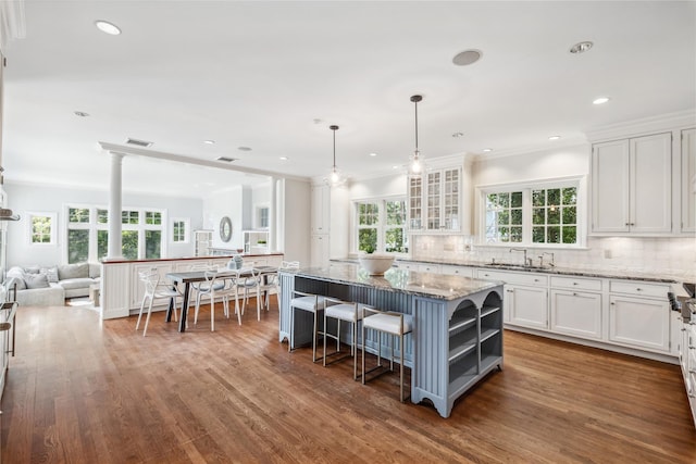 32 Pryer Ln, Larchmont, NY 10538 - kitchen with visible vents, light stone countertops, a sink, open floor plan, and white cabinetry